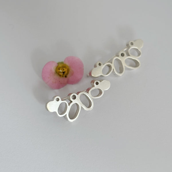 Spring along silver climber earrings